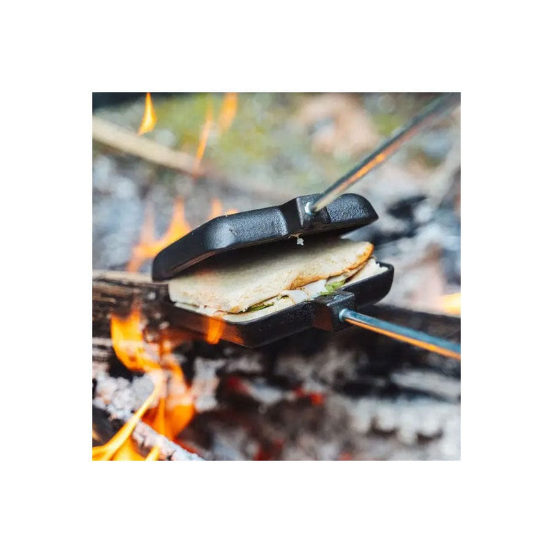 Load image into Gallery viewer, Campfire with a portable grill holding food over flames
