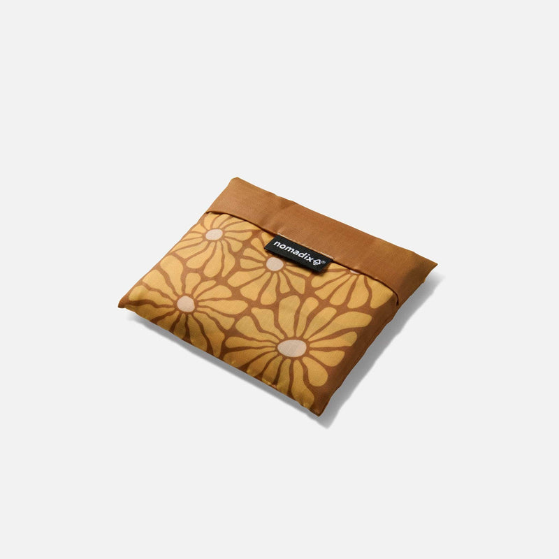 Load image into Gallery viewer, Floral-patterned pouch with a brand label on a white background
