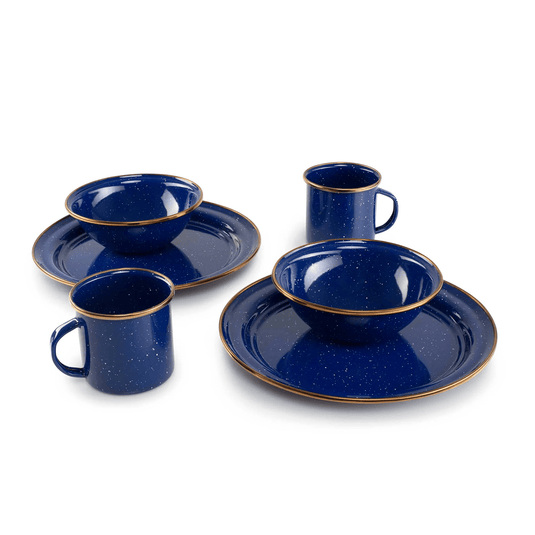 Set of blue ceramic dinnerware with gold rims on a white background