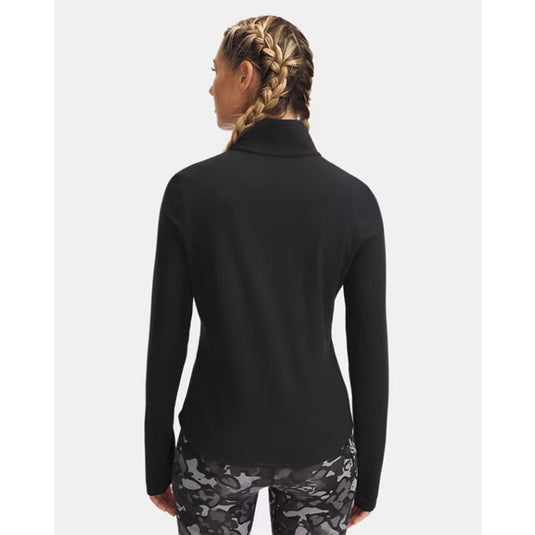 Person wearing a black long-sleeve top and patterned leggings on a white background