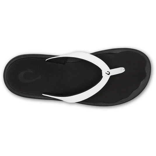 Black sandal with white strap on a white background