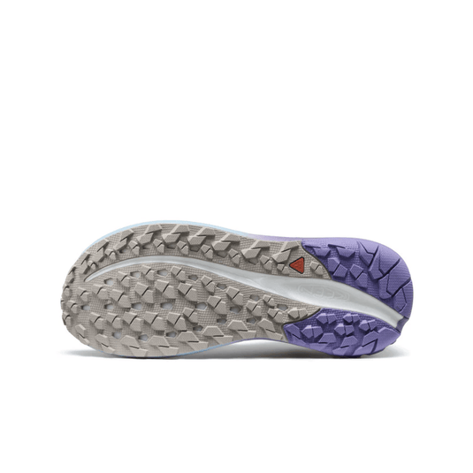 Close-up of a shoe sole with purple outsole and textured pattern on a white background